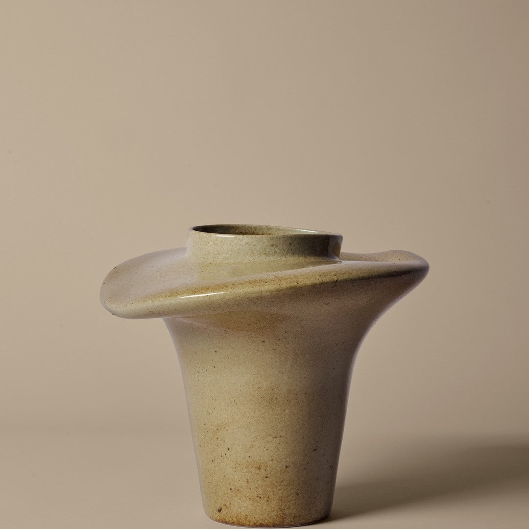 Beige ceramic vase with a sculptural design, featuring a smooth, curved shape and subtle speckled texture.