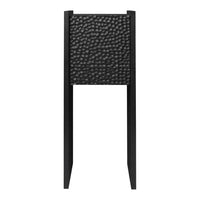 Black textured panel with a hammered pattern on a sleek black stand. Modern aesthetic for contemporary decor.