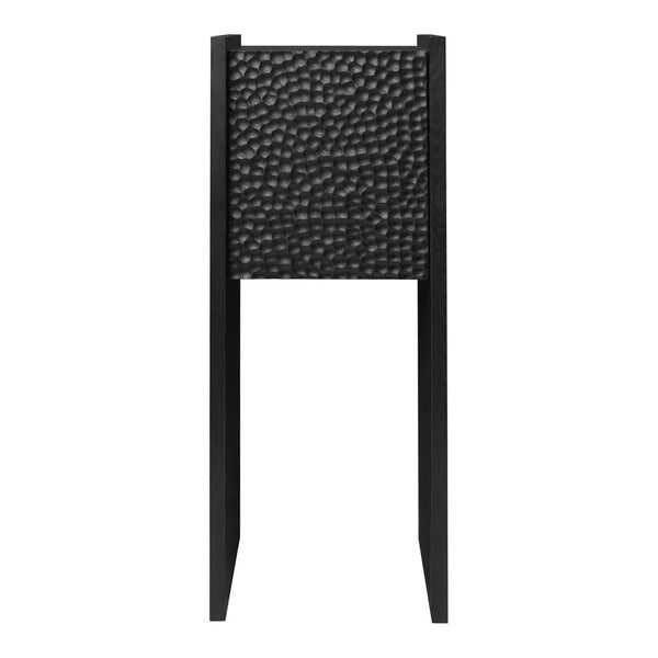 Black textured panel with a hammered pattern on a sleek black stand. Modern aesthetic for contemporary decor.