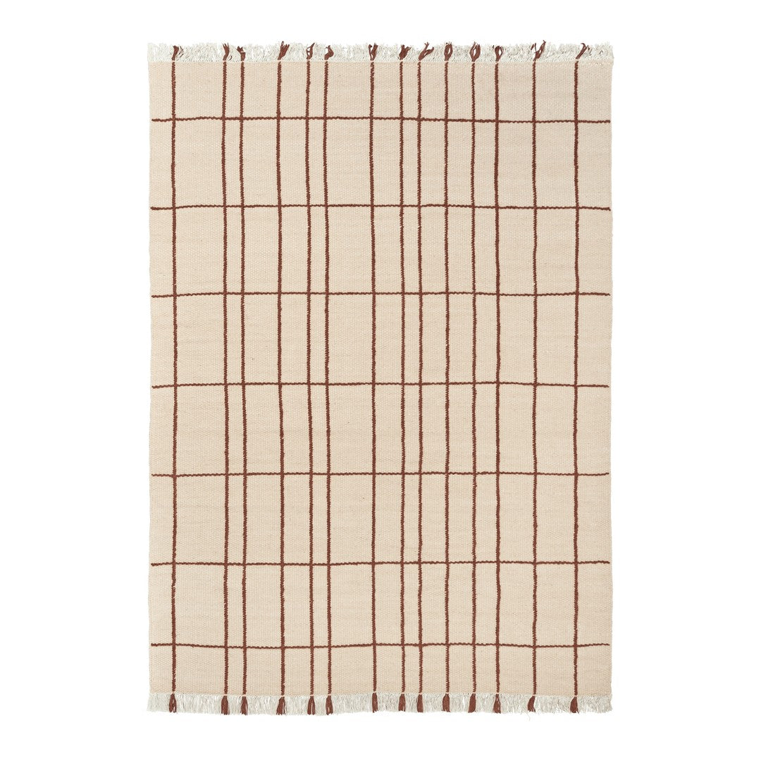 Beige cotton blanket with a brown grid pattern and fringed edges. Perfect for adding texture to any space.