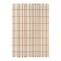 Beige cotton blanket with a brown grid pattern and fringed edges. Perfect for adding texture to any space.