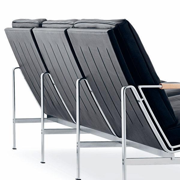 Black slatted upholstery with sleek chrome legs, offering a modern minimalist design. Perfect for contemporary spaces.
