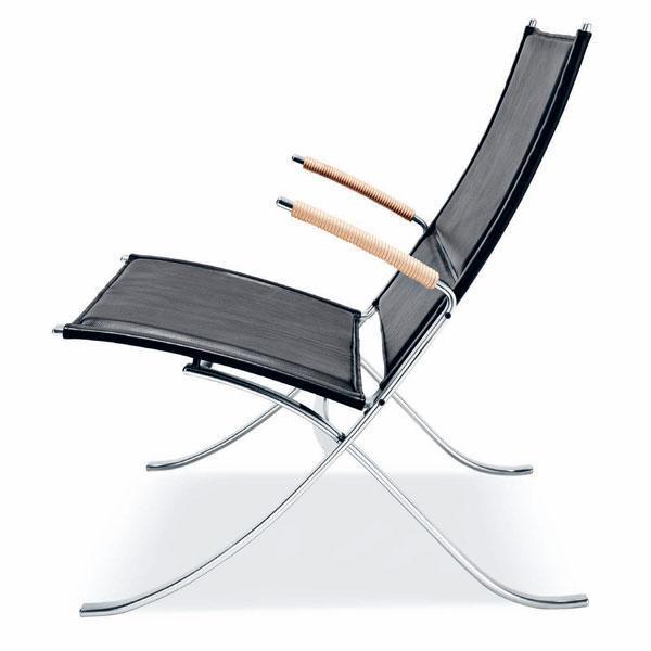 Black mesh lounge chair with sleek chrome frame and natural wood accents. Modern, minimalist design for stylish seating.