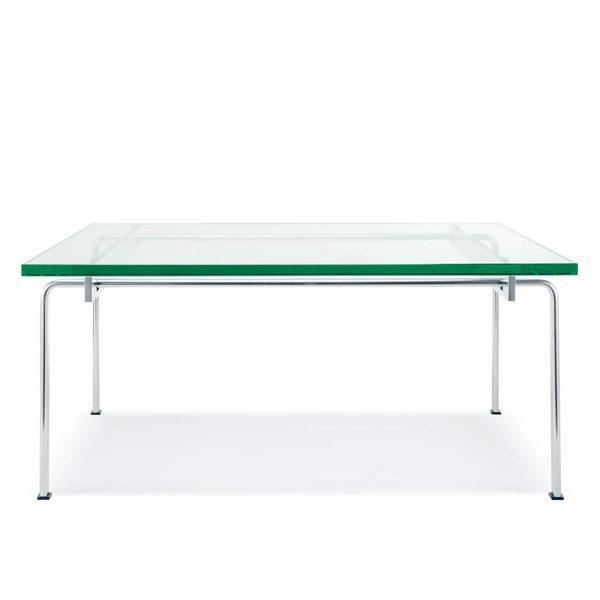 Transparent glass table with a green-tinted edge and sleek chrome legs, showcasing minimalistic modern design.
