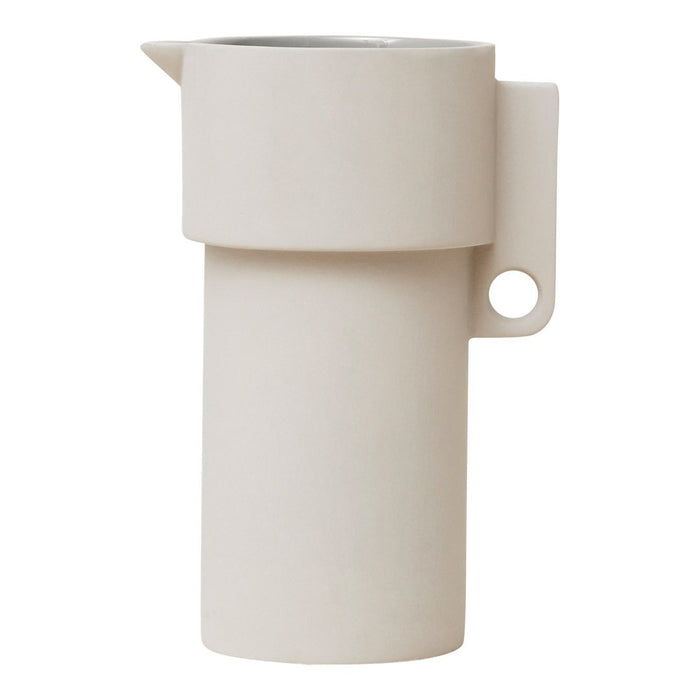 Light beige ceramic pitcher with a smooth, minimalist design and a matte finish. Perfect for modern decor.