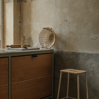 Neutral tones with warm wood grain and rustic textured walls, featuring natural materials and minimalist design.