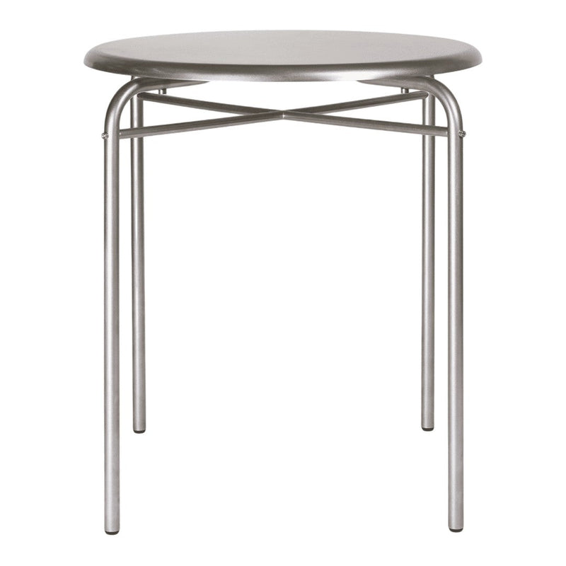 Silver round table with a minimalist design and crisscross metal legs, perfect for modern interiors.