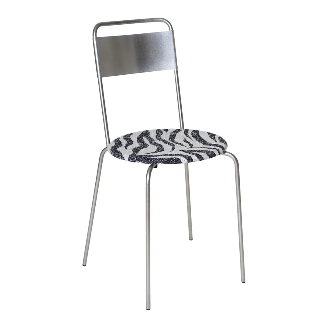 Zebra-patterned round seat with sleek silver metal frame. Stylish black and white design for modern decor.