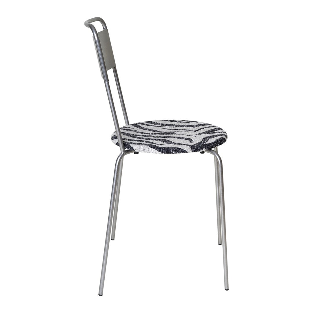 Zebra-patterned seat with monochrome black and white colors on a sleek, silver metal chair frame.