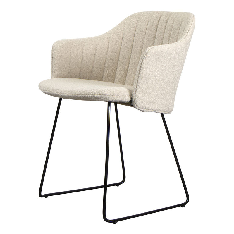 Beige upholstered chair with subtle vertical ribbing and sleek black metal legs. Perfect for modern decor.