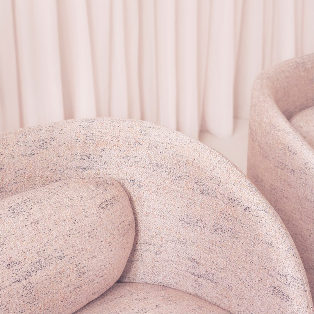 Textured pink upholstery featuring subtle speckles in pastel hues. Soft curves complement a warm, inviting aesthetic.