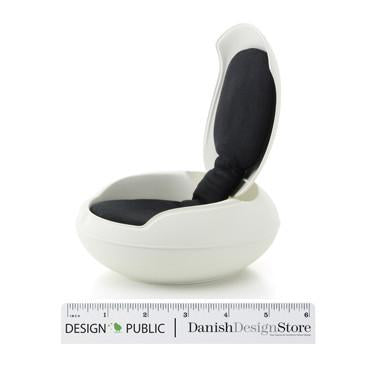 White modern chair with a smooth, curved shape and a deep black cushion for contrast. Perfect blend of elegance and comfort.