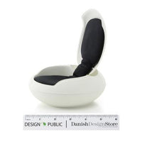 White modern chair with a smooth, curved shape and a deep black cushion for contrast. Perfect blend of elegance and comfort.