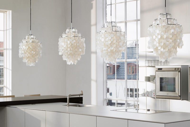 White pendant lights with a unique layered petal pattern, adding elegance to a modern kitchen interior.