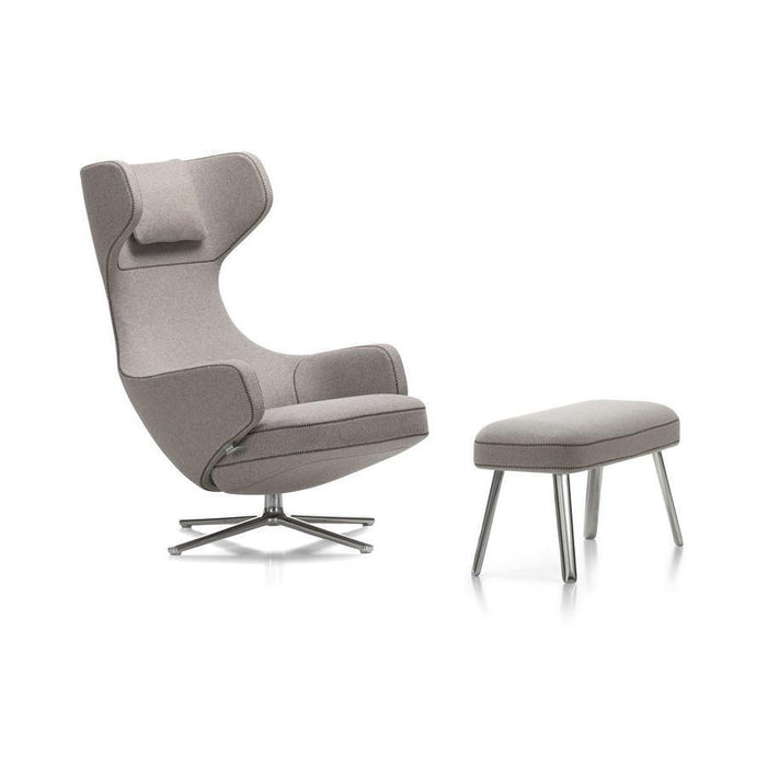 Gray upholstered chair with a modern design and matching ottoman, featuring smooth lines and a sleek metal base.
