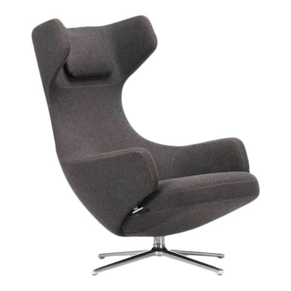 Dark gray upholstered lounge chair with smooth, minimalist design and chrome base. Perfect for modern decor.