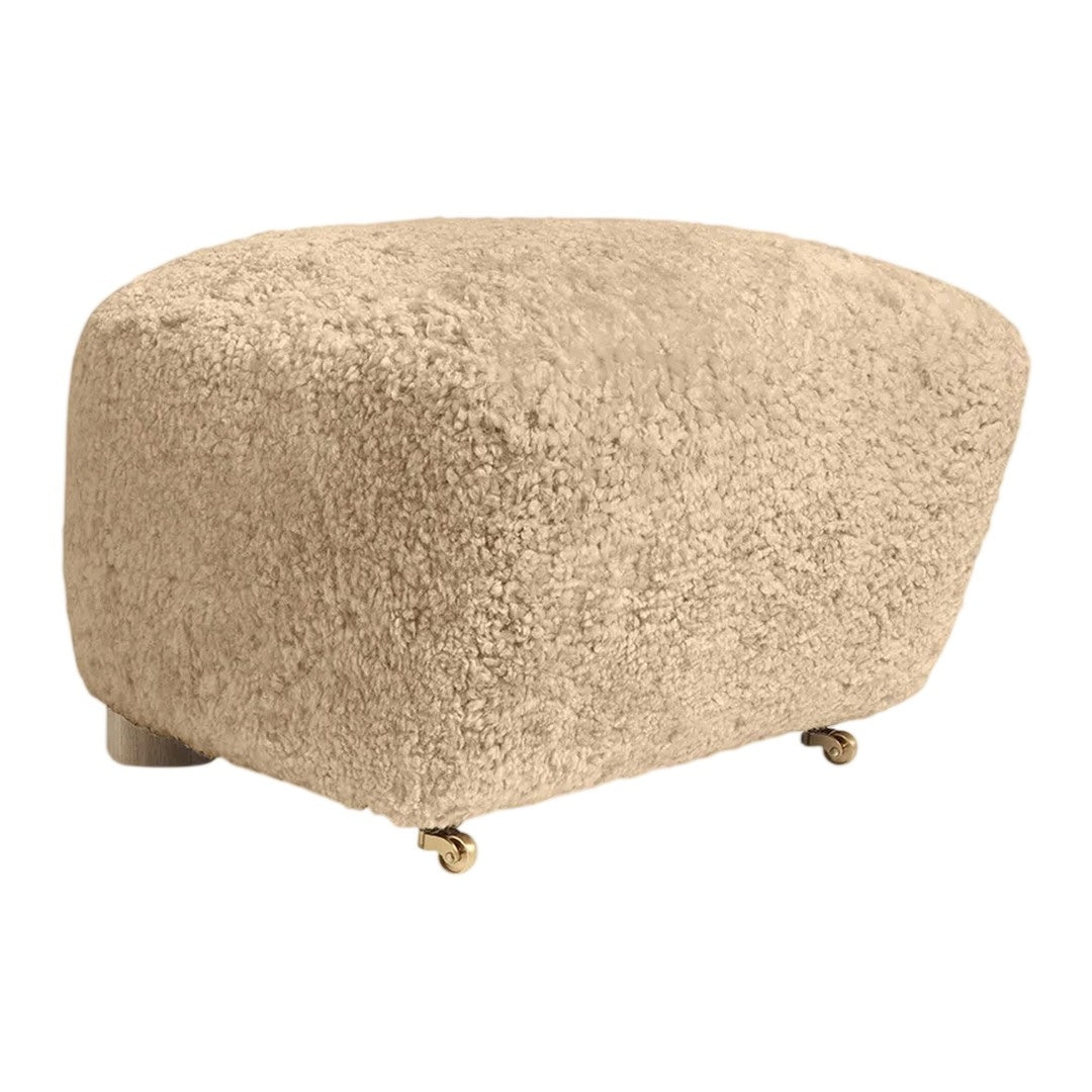 Beige textured ottoman with a soft, shaggy pattern and rolling wheels for easy mobility.