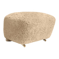Beige textured ottoman with a soft, shaggy pattern and rolling wheels for easy mobility.