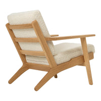 Light beige upholstered chair with soft textured fabric and natural wooden frame. Simple, modern design.