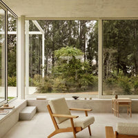 Natural tones of beige and green with minimalist design elements and a focus on light and space.