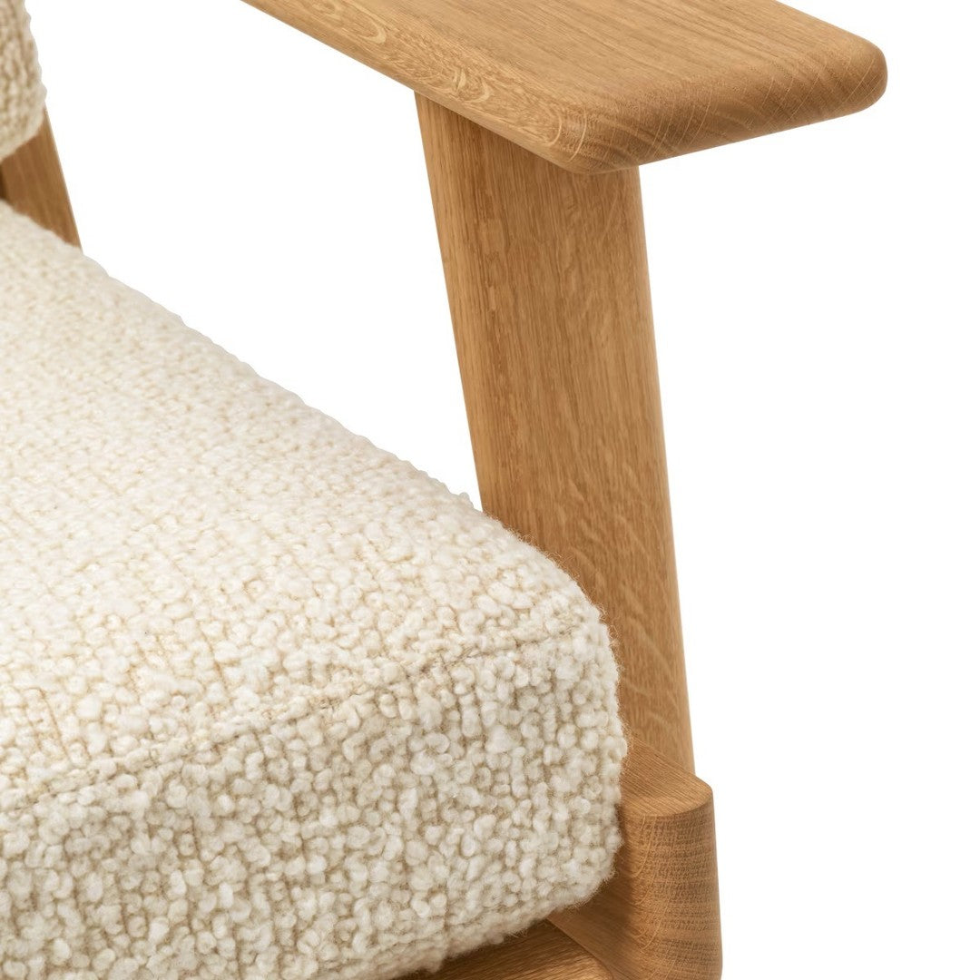 Cream textured fabric with a natural wood armrest, showcasing a minimalist and modern design. Perfect for contemporary decor.