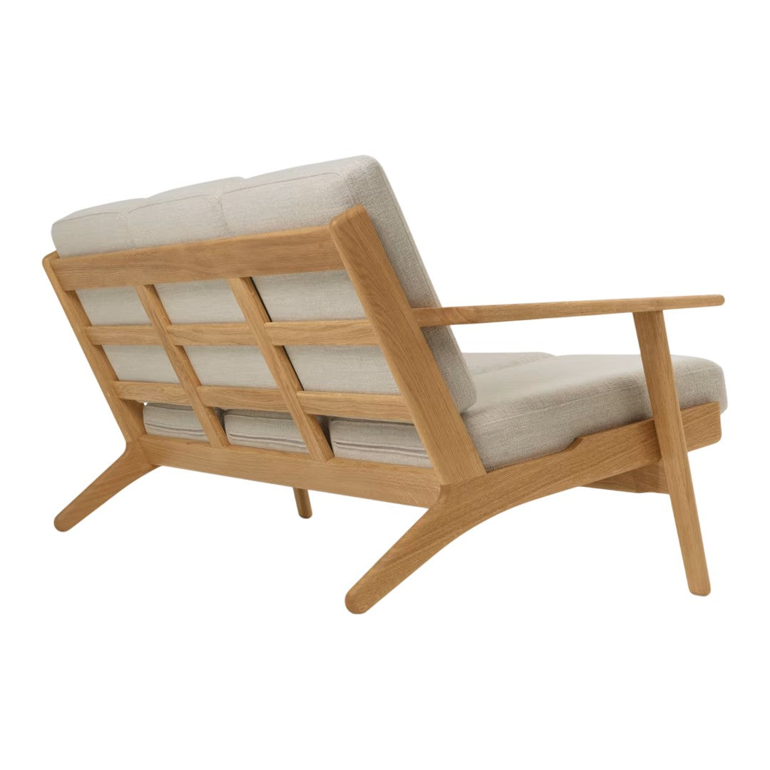 Light beige fabric cushions on a wooden frame with a natural finish and grid pattern. Modern Scandinavian design.