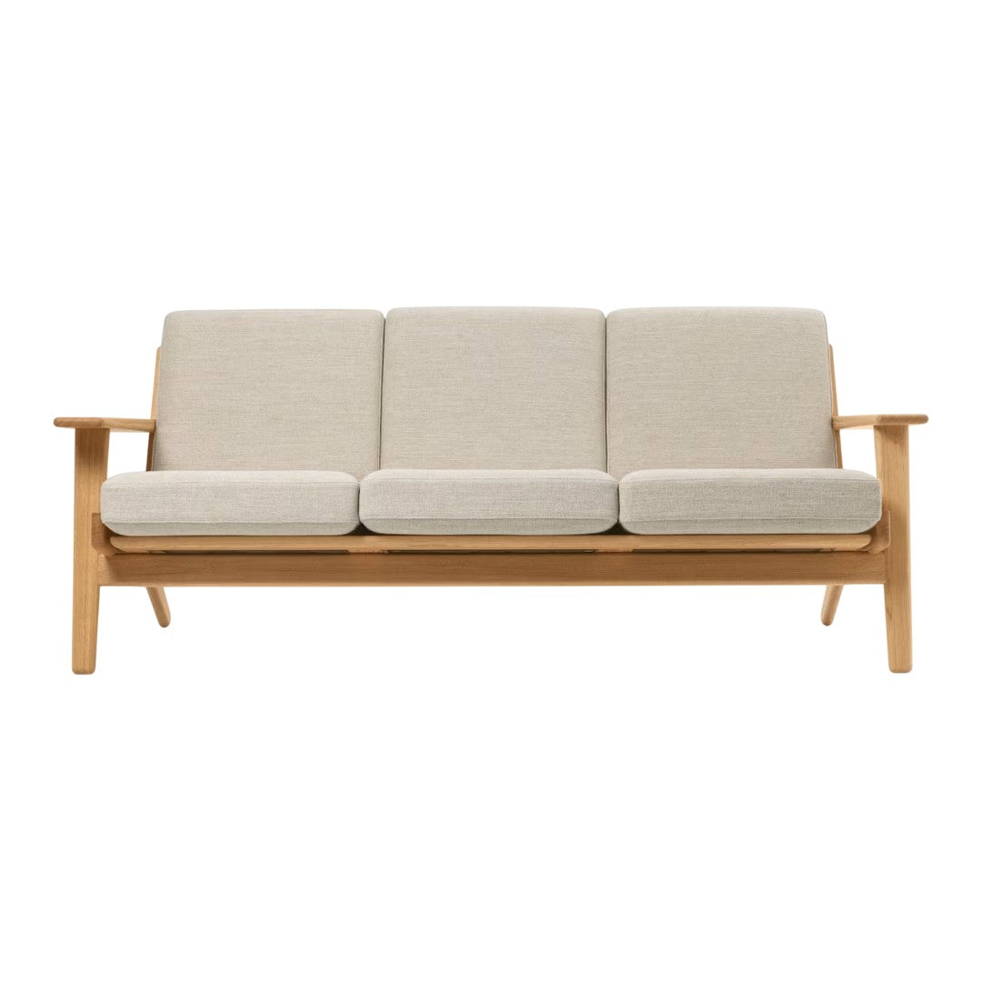 Light beige fabric cushions on a natural wood frame, offering a minimalist and modern design. Perfect for any decor.