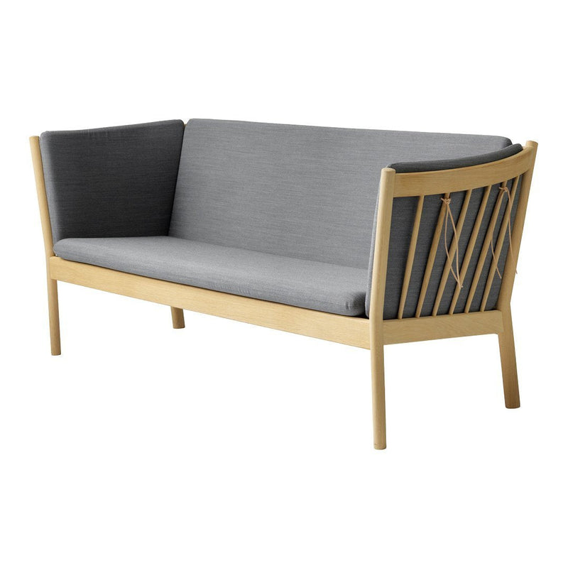 Modern sofa in gray fabric with a wooden frame and slatted back design. Minimalist style with neutral color palette.