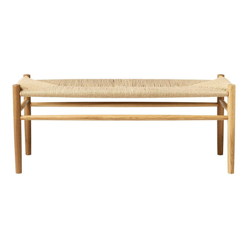 Natural wood bench with a woven beige seating surface, featuring a minimalist design and earthy tones. Perfect for any space.