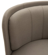 Curved chair detail showcasing soft taupe fabric with subtle stitching patterns for a sleek, modern look.