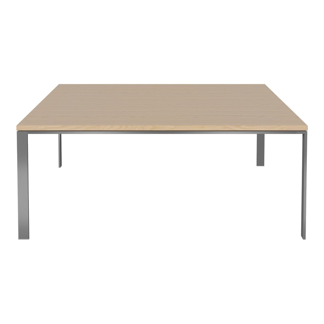 Modern square table with a light wood finish and sleek silver metal legs. Minimalist design with neutral tones.