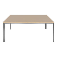Modern square table with a light wood finish and sleek silver metal legs. Minimalist design with neutral tones.