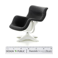 Stylish black swivel chair with smooth curves and a white base, perfect for modern interiors.
