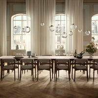 Elegant wooden dining table with light wood tones, paired with soft neutral curtains and decorative glass pendant lights.