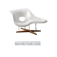 White modern chair with a smooth, curved design and natural wood legs, featuring a distinctive hole pattern.