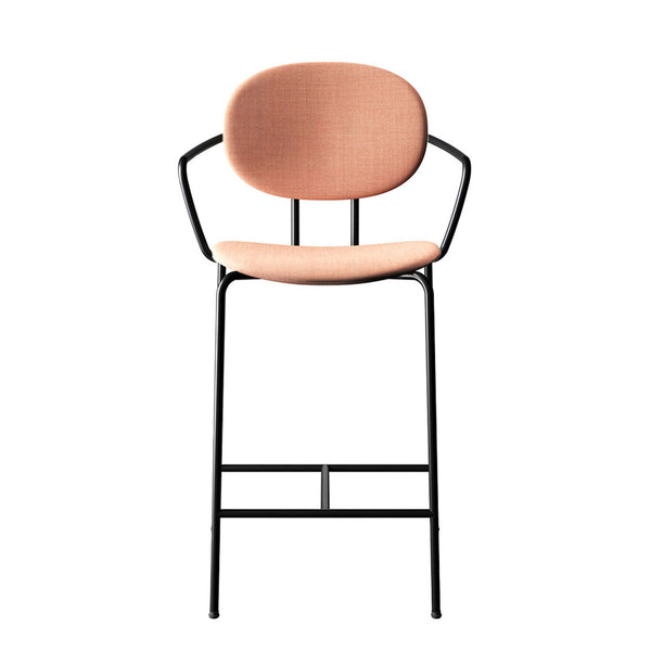 Peach fabric seat with a smooth texture, set on a sleek black metal frame. Modern and stylish design.