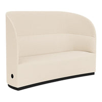 Cream-colored curved sofa with minimalist design and black base, perfect for modern decor.