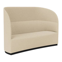 Beige curved sofa with a smooth, textured fabric and a sleek black base, perfect for modern interiors.