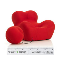 Bright red modern lounge chair with playful bubble shapes and a matching round ottoman. Smooth, vibrant upholstery.