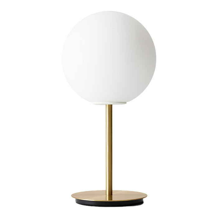 Modern table lamp featuring a white globe shade, brass stem, and black base for stylish contrast.