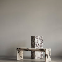 Marble table set featuring striking black and white veining against a minimalist backdrop, showcasing elegant patterns.