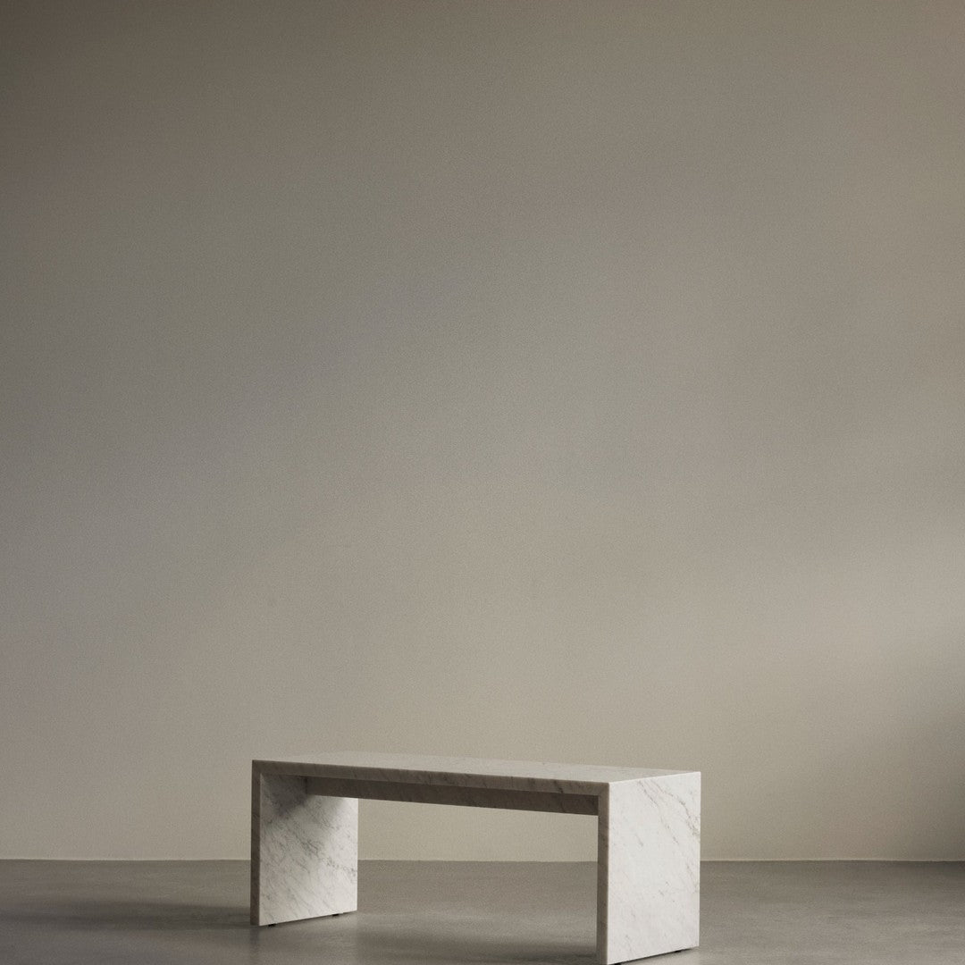 Minimalist gray marble table with subtle white veining against a neutral background. Perfect for modern decor.