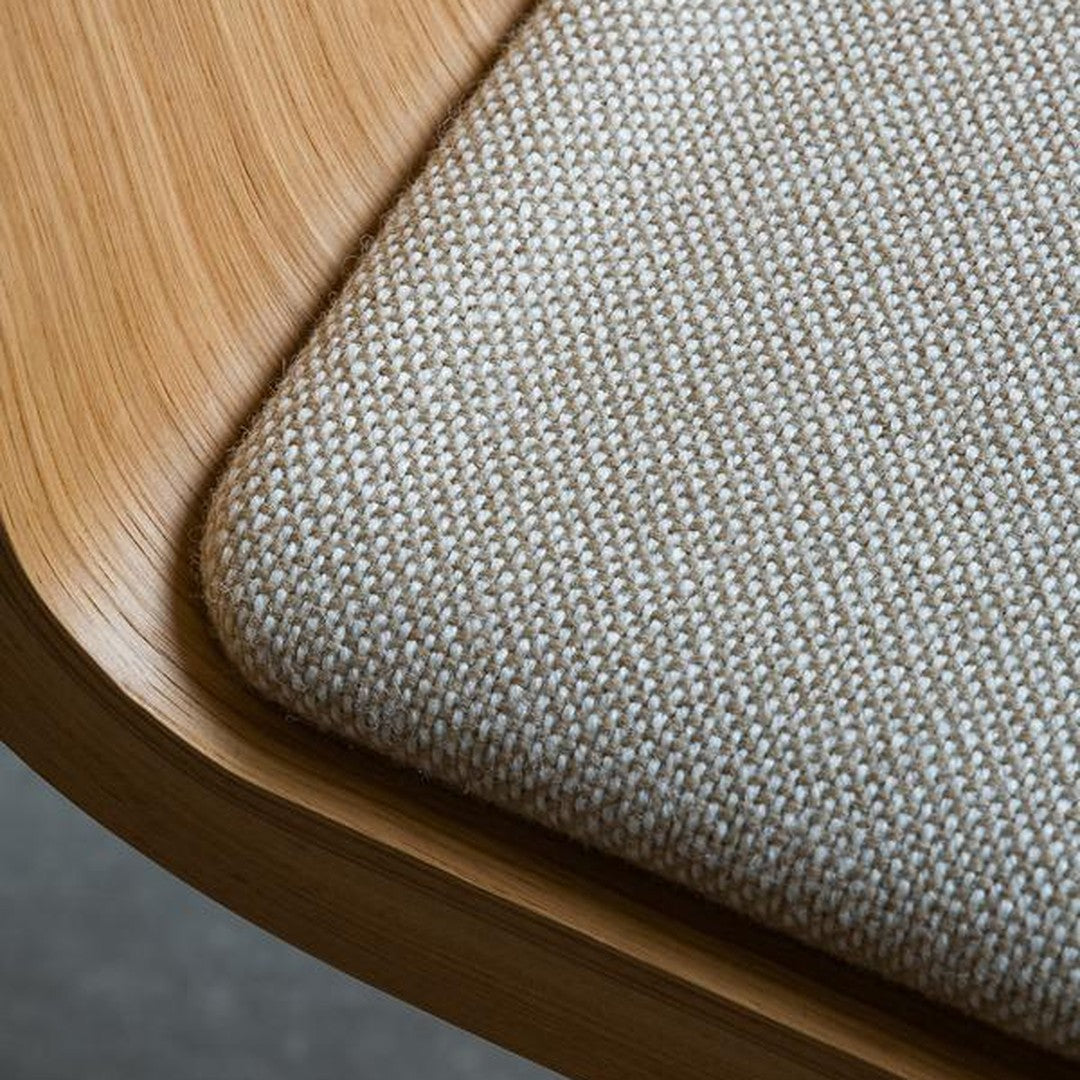 Light beige textured fabric against a natural woodgrain edge, highlighting a modern, minimalist design.