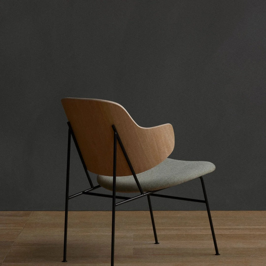 Light wood and gray fabric chair with minimalist design and black metal legs, perfect for modern interiors.