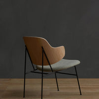 Light wood and gray fabric chair with minimalist design and black metal legs, perfect for modern interiors.