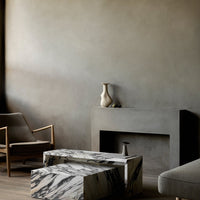 Elegant gray wall backdrop with a textured finish, complemented by a striking black-and-white marbled coffee table.
