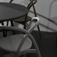Gray, black, and brown furniture with minimalist design and smooth curves, highlighting elegant color contrast and shadows.
