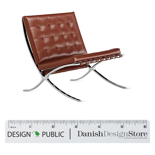 Brown leather chair with tufted design and sleek chrome legs, ideal for modern interiors.