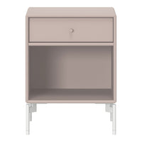 Blush pink nightstand with a smooth finish and white metal legs, featuring a minimalist design and single drawer.