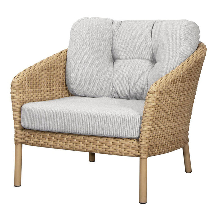 Light gray cushioned chair with woven natural rattan frame and light wooden legs, showcasing a contemporary design.